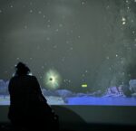 Interior view of Starlab, a portable inflatable planetarium, showing a dark dome-shaped space with projected stars and constellations on the ceiling.