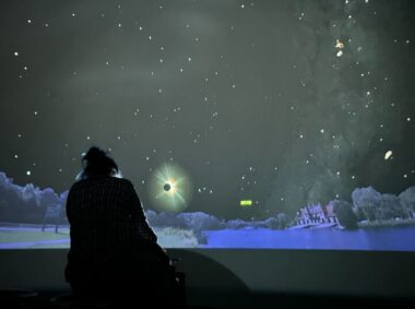Interior view of Starlab, a portable inflatable planetarium, showing a dark dome-shaped space with projected stars and constellations on the ceiling.