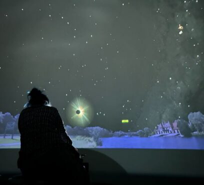 Interior view of Starlab, a portable inflatable planetarium, showing a dark dome-shaped space with projected stars and constellations on the ceiling.