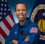 A photo of Chris Williams in his blue NASA flight suit.