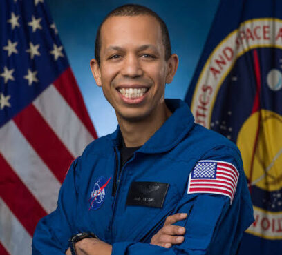 A photo of Chris Williams in his blue NASA flight suit.