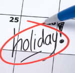 The word holiday is written on a calendar and circled in red pen.
