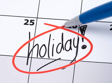The word holiday is written on a calendar and circled in red pen.