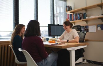 Professor Anna-Christina Eilers chats with two of her students.