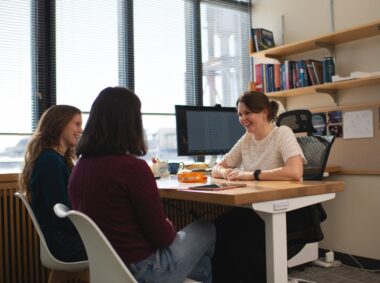 Professor Anna-Christina Eilers chats with two of her students.