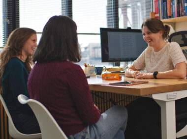 Professor Anna-Christina Eilers chats with two of her students.